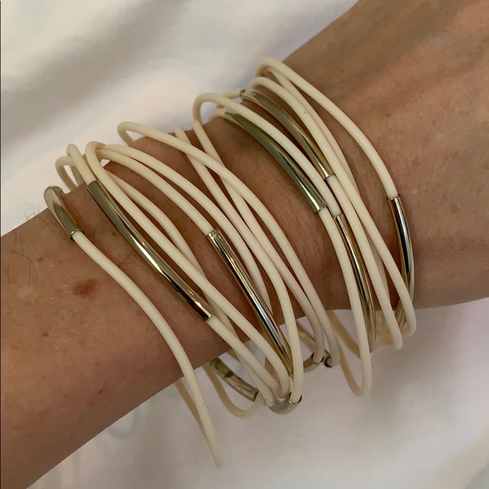 Stack of ivory and gold bracelets
